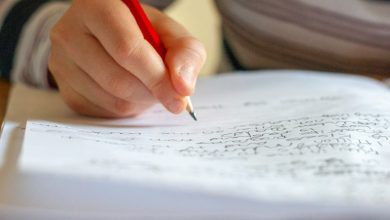 person writing on white paper